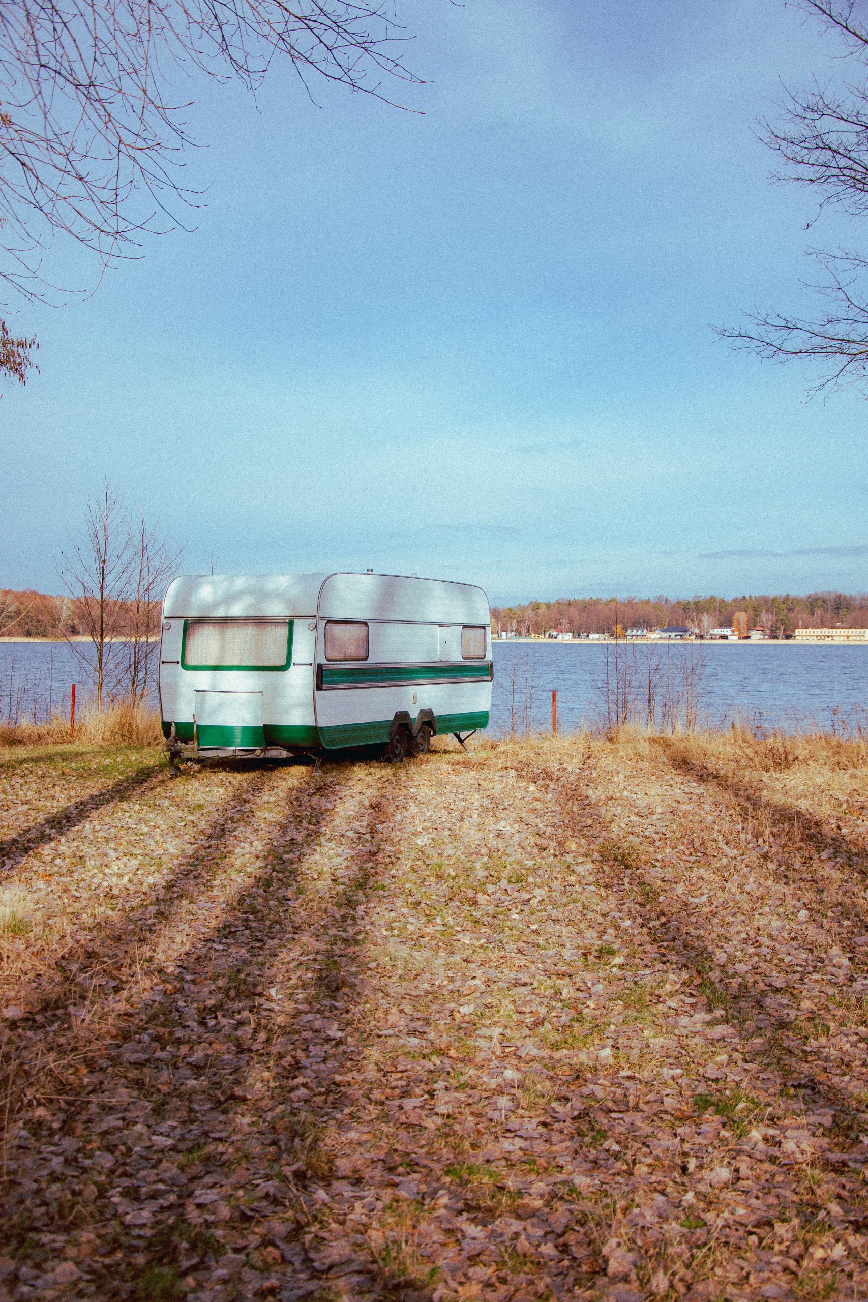 A caravan by the lake. Enjoy the stay longer with caravan solar panels UK.