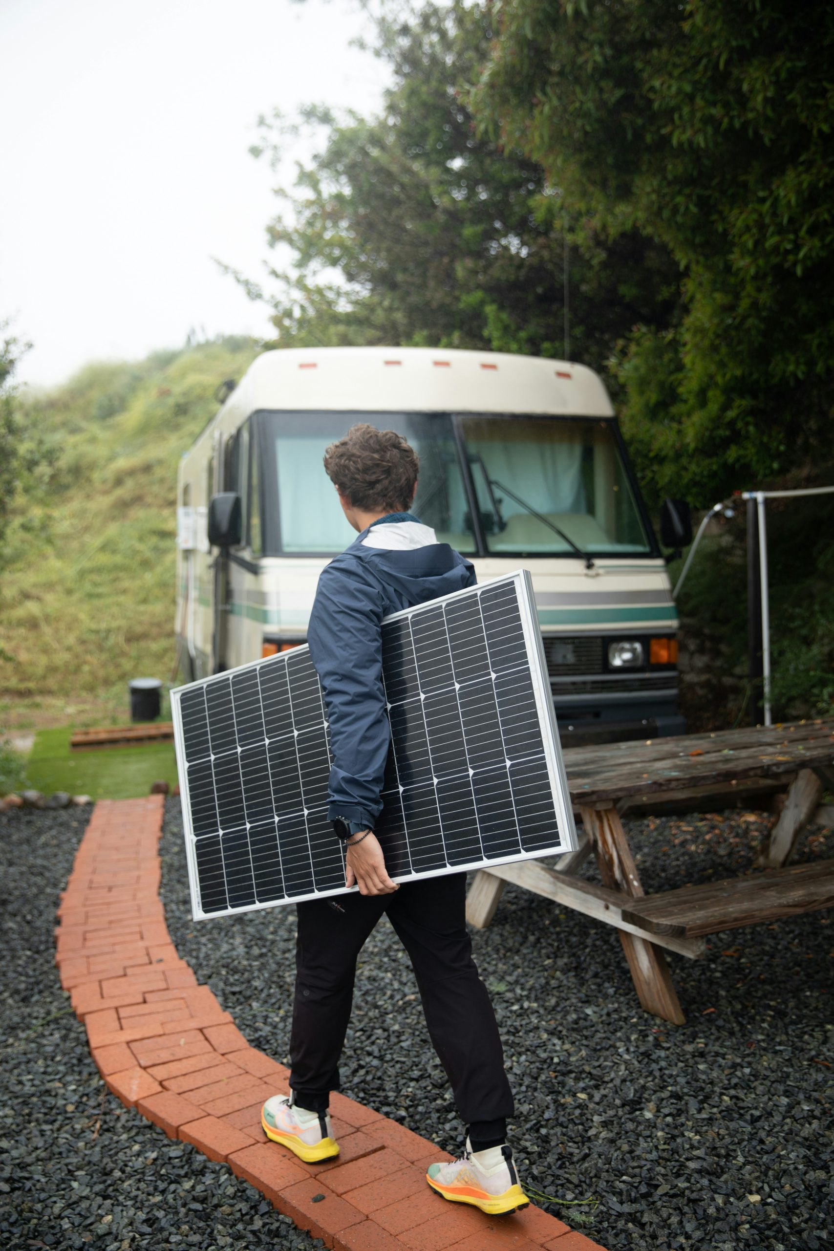 camper van solar panels guy camper van solar panels guy walking for his van with the panels in hand